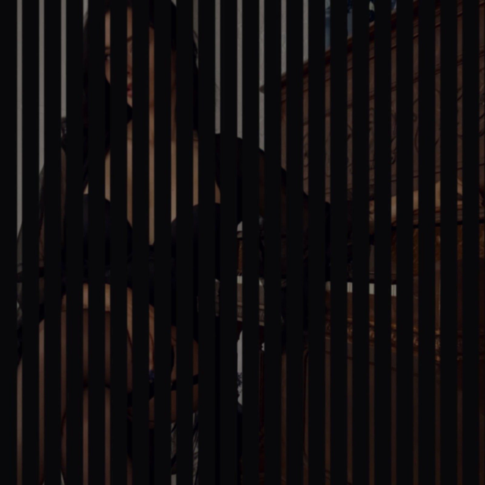 The August Set — glimpsed through a slatted door